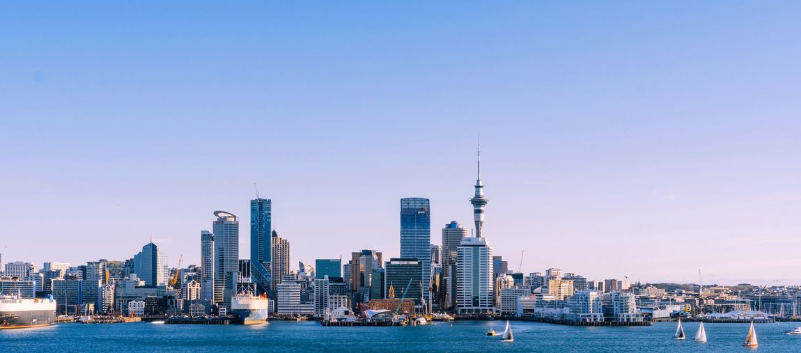 Student with the Auckland skyline, New Zealand